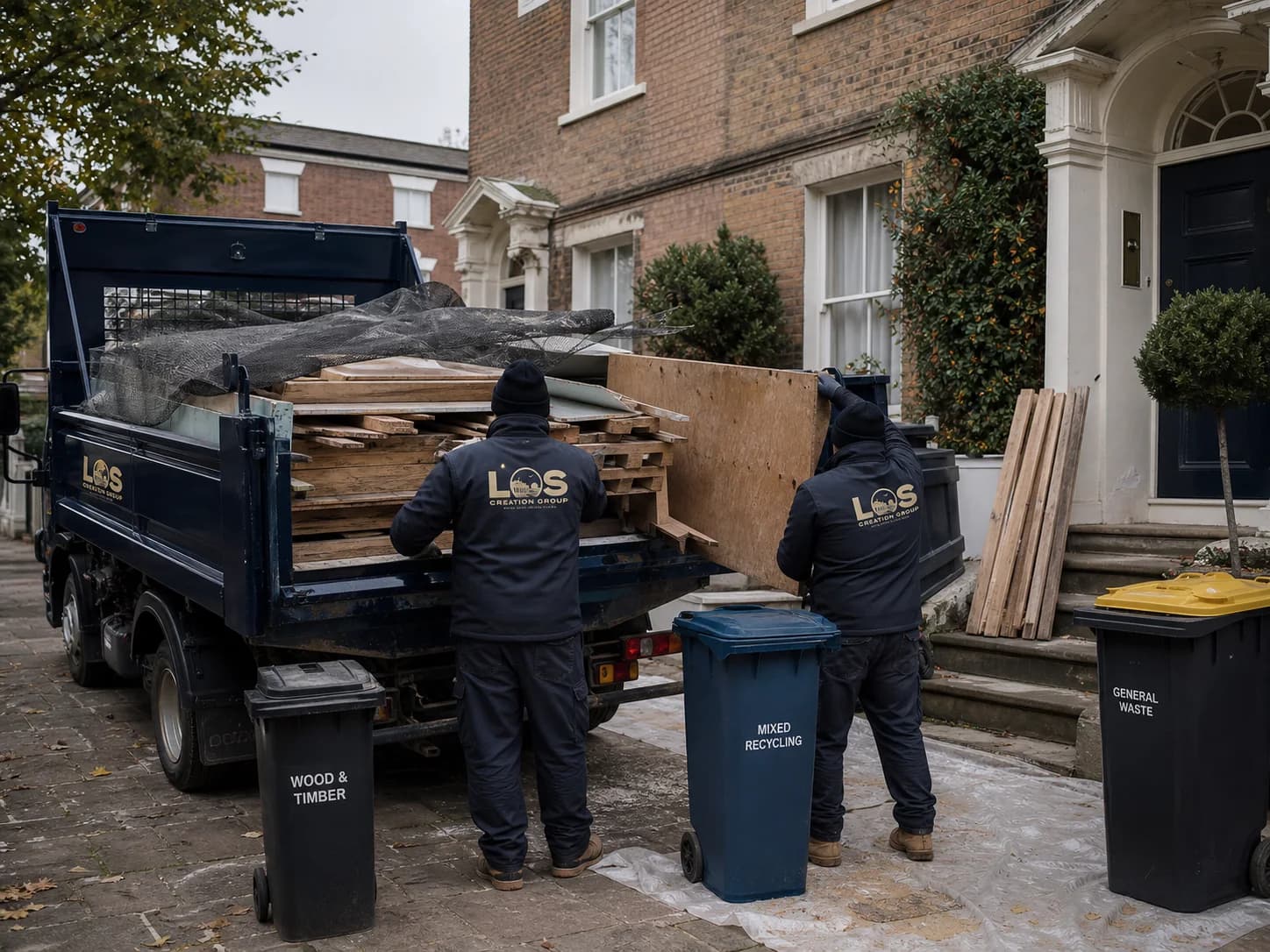 Editorial concept of a professional team sorting and loading renovation waste at an Essex property